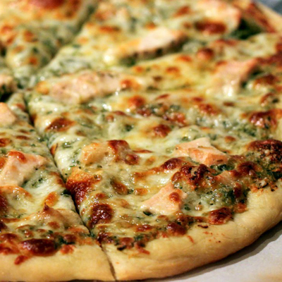 The perfect pizza crust with chicken, roasted garlic, and pesto! Thinking about making your own pizza dough? This is the recipe you need!
