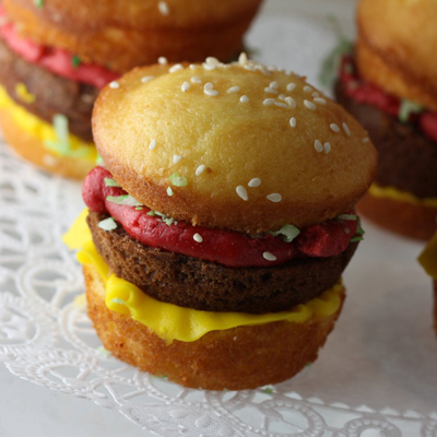 It sure looks like a picture perfect burger, but it's a...CUPCAKE! chocolate cupcake burger, vanilla cupcake buns, coconut lettuce and frosting condiments.