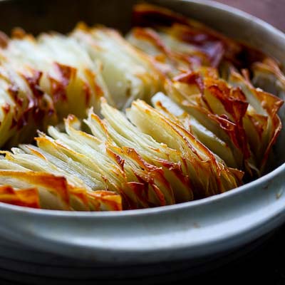 Potatoes made to look like falling stack of cards or dominoes. Only 3 ingredients! Potatoes, salt and butter.