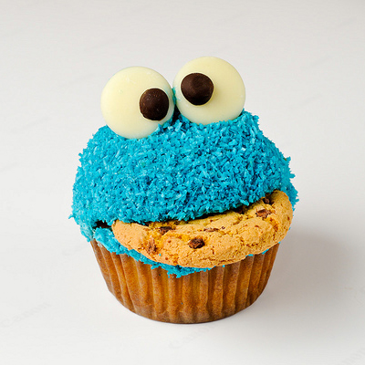 A Cookie Monster Cupcake and appropriately enough eating a cookie.