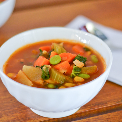 Vegan vegetable soup with kale and edamame.