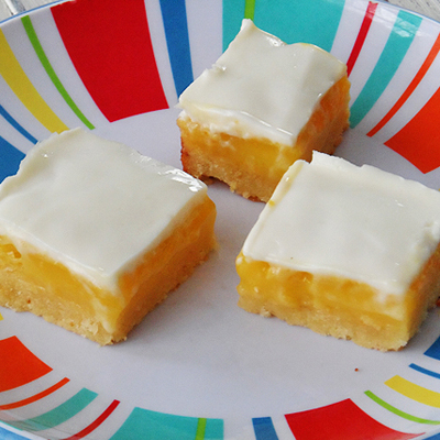 The tangy taste of lemon bars with a sweet creamy topping, perfect for warm days ahead!