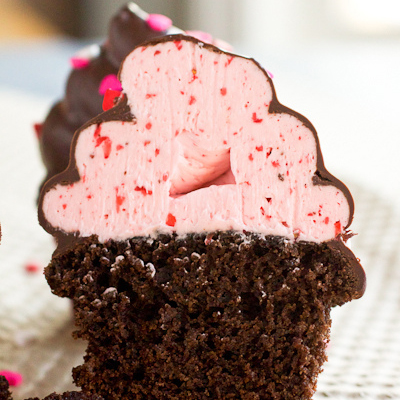 Recipe for Chocolate Covered Strawberry Cupcakes - Strawberry Swiss meringue buttercream dipped in chocolate make these cupcakes taste like a luscious chocolate dipped strawberry.