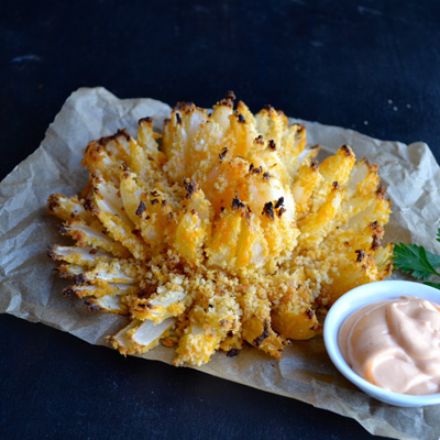 Buffalo Baked Blooming Onion - with just a bit of olive oil, you can enjoy your Blooming Onion with no guilt at all! Includes recipe for a dipping sauce...
