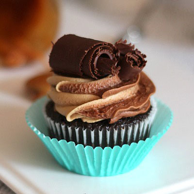 Chocolate and Caramel Swirl Cupcakes. Devil’s food cake cupcake, filled with caramel sauce, topped with a chocolate buttercream caramel frosting swirl, garnished with chocolate curls... basically the BEST Chocolate Caramel Swirl Cupcake you will ever have!