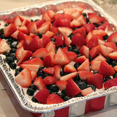 Graham cracker crust, whipped cream, cream cheese, vanilla pudding, and sweet berries all in this dessert. A perfect treat for the hot summer months!