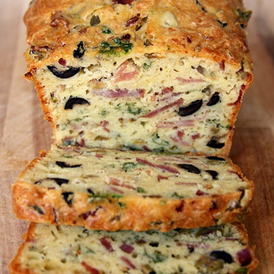 Olive, Bacon and Cheese Bread~T~ serve as an appetizer or grab a slice for a quick lunch on the go. This bread if full of bacon, ham, cheese, onion, white wine, olive oil and black and green olives. A delicious quick bread.