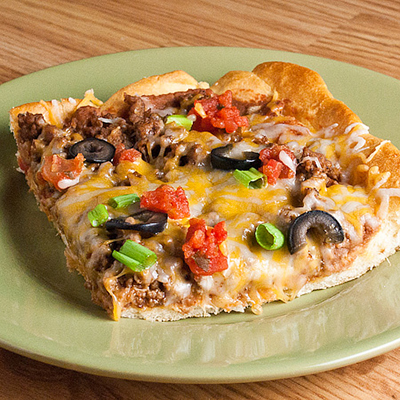 Taco Pizza - The great thing about this recipe is you can cut it into large squares and serve it as a main dish or cut it into smaller squares and serve it as an appetizer. This was yummy and easy to put together.