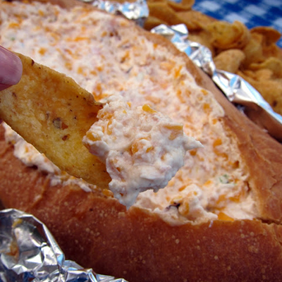 MISSISSIPPI SIN DIP sour cream, cream cheese , cheddar cheese, ham, French loaf bread. Mix ingredients, hollow out the loaf creating a "boat", pour mixture in loaf, wrap in foil, bake at 350 for 1 hour.