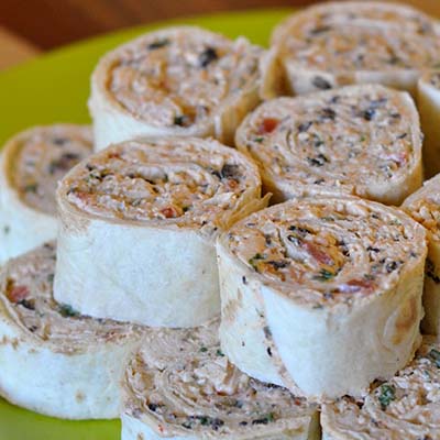 Creamy Chicken Enchilada Rollups—Great party appetizer! Easy to make ahead of time and travels great!