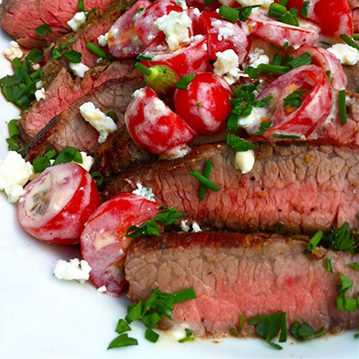 Grilled flank steak with Greek gorgonzola and tomato salsa.