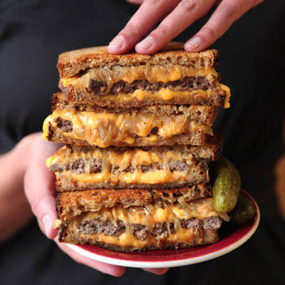 Patty Melt - Some say that the patty melt — a grillled sandwich of ground beef, caramelized onions, cheese, and rye bread — isn't technically a burger, because it has no bun. We love it just the same.