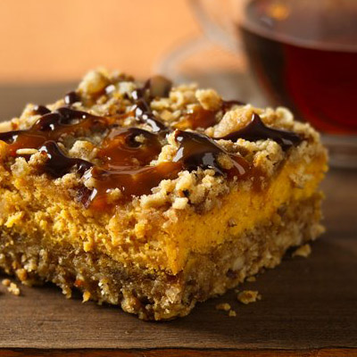 Pumpkin Streusel Cheesecake Bars - Chocolate and caramel drizzles add a new flavor punch to creamy pumpkin-oat bars.