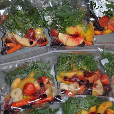 Basically, you make pre-made frozen smoothies bags. Then in the morning, you pull one out, add some orange juice and blend... that's it! Here's how it works. Buy all your fruits and veggies. Cut, slice and dice and then separate into bags.