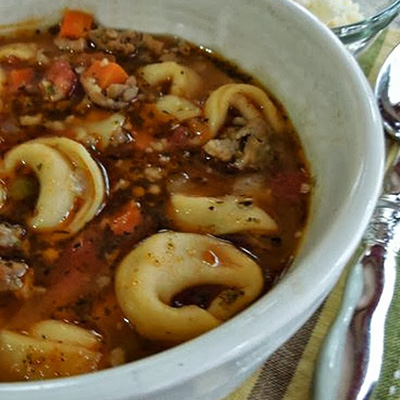 Italian Tortellini Soup is hearty and warm but not heavy. Perfect for Fall or any time of year. Sausage, carrots, tomatoes and Parmesan cheese make it a total meal.