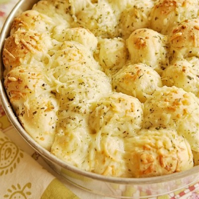 Garlic Cheese Pull-Apart Bread 16 frozen white dinner rolls (Rhodes brand) ½ C butter, melted 1 C grated Parmesan cheese, divided 1 tsp dry parsley flakes 1½ tsp garlic powder ½ tsp salt ½ tsp Italian seasoning ½ tsp onion powder. This bread is yummy!