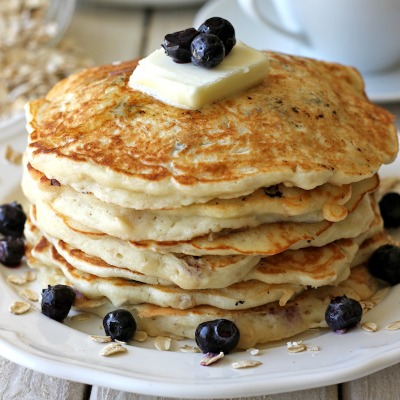 Blueberry Oatmeal Yogurt Pancakes - Start your mornings off right with these light and healthy pancakes loaded with juicy blueberries! Blueberries are great for heart health, so this delicious recipe is a win-win. Breakfast will never be the same!